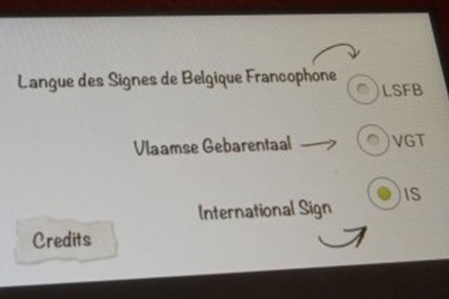 벨기에왕립미술관의 수어해설 비디오 가이드 패드. 벨기에-프랑스 수어(LSFB), 플랑드르 수어(VGT), 국제 수어(ISL) 선택 옵션이 보인다.